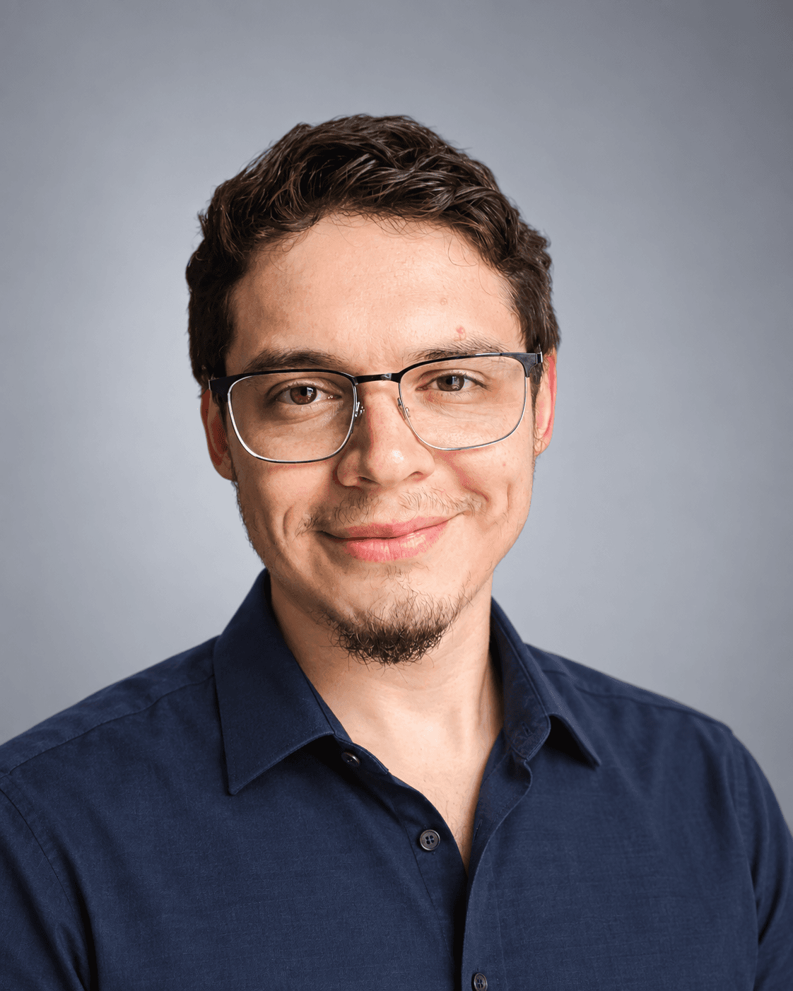 Joshua Palacios wearing glasses and a navy shirt